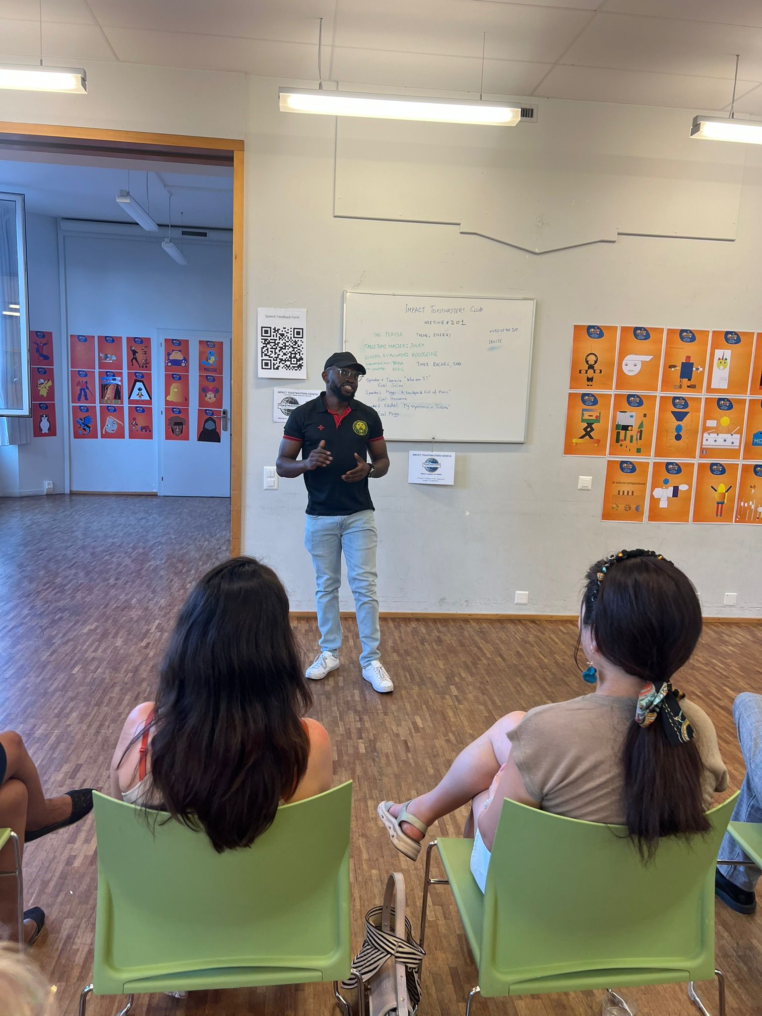 Impact Toastmasters members welcoming guests at a meeting
